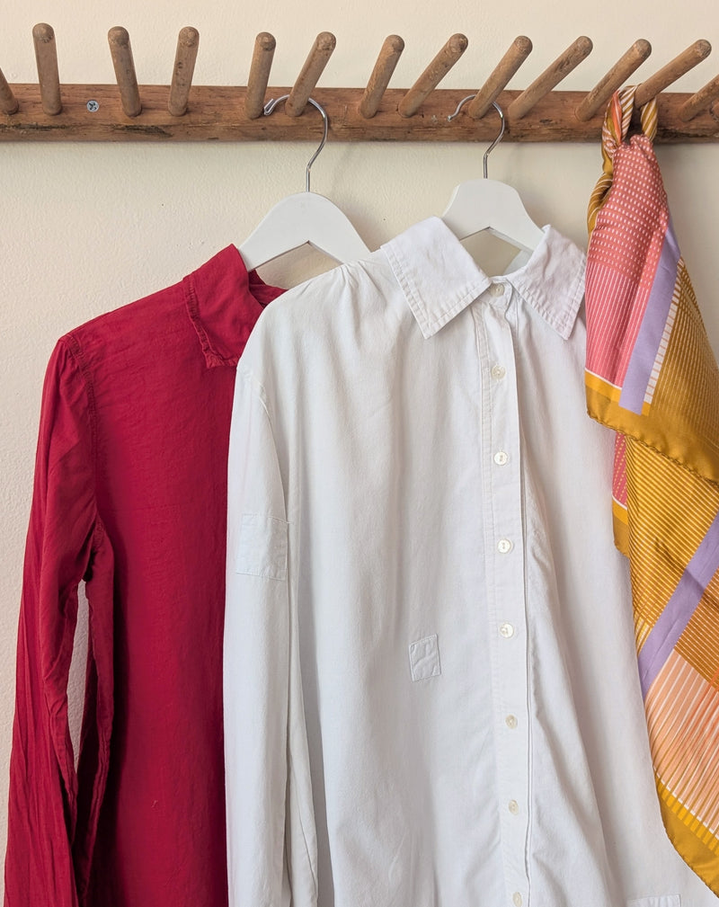 Red and white shirts hanging on a wooden rack against a neutral wall.

Auntie Oti button down khadi cotton lightweight shirt sowa boston small business gift shop boutique