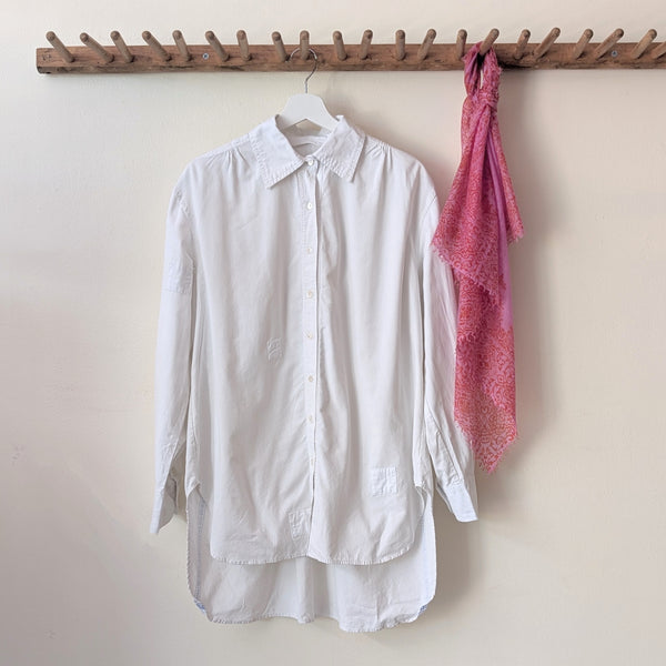 White shirt and pink scarf hanging on a wooden rack against a white wall.

Auntie Oti button down cotton oversized upcycled shirt sowa boston small business gift shop boutique