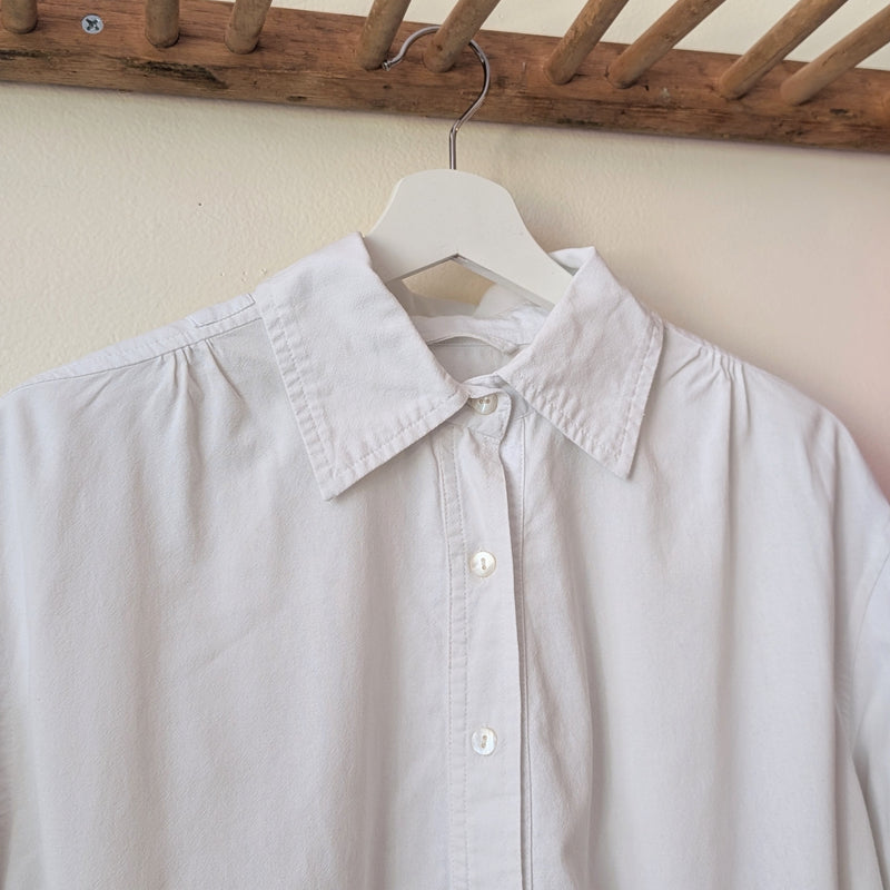 Light gray shirt on a hanger against a neutral wall

Auntie Oti button down cotton oversized upcycled shirt sowa boston small business gift shop boutique