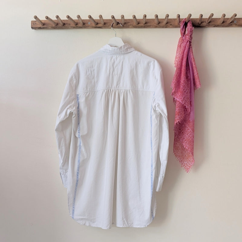 White shirt and pink scarf hanging on a wooden rack against a beige wall.

Auntie Oti button down cotton oversized upcycled shirt sowa boston small business gift shop boutique