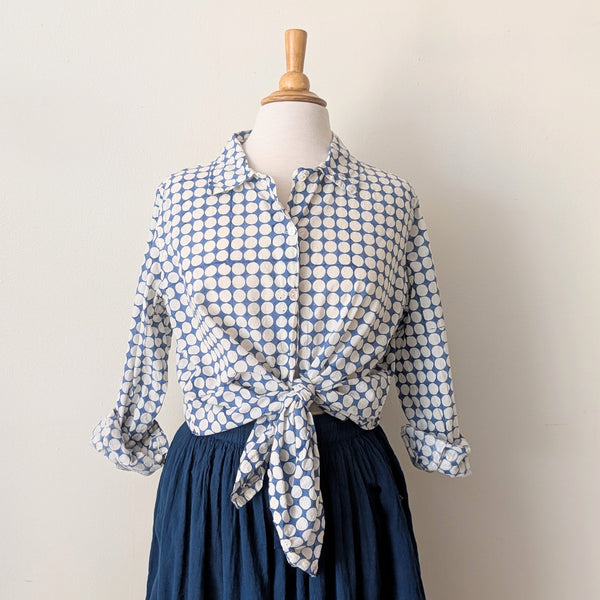 Blue and white patterned blouse tied at the waist on a mannequin against a plain background

Auntie Oti button down cotton shirt polka dot block printed sowa boston small business gift shop boutique