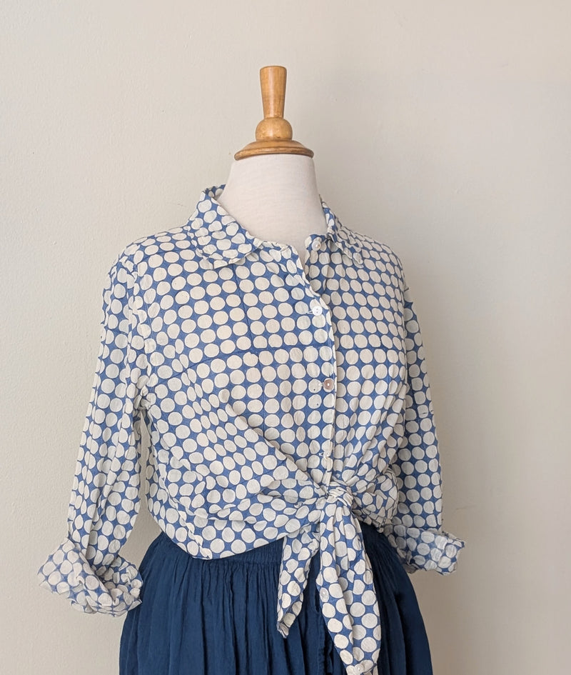 Blue and white polka dot blouse on a mannequin against a plain background

Auntie Oti button down cotton shirt polka dot block printed sowa boston small business gift shop boutique