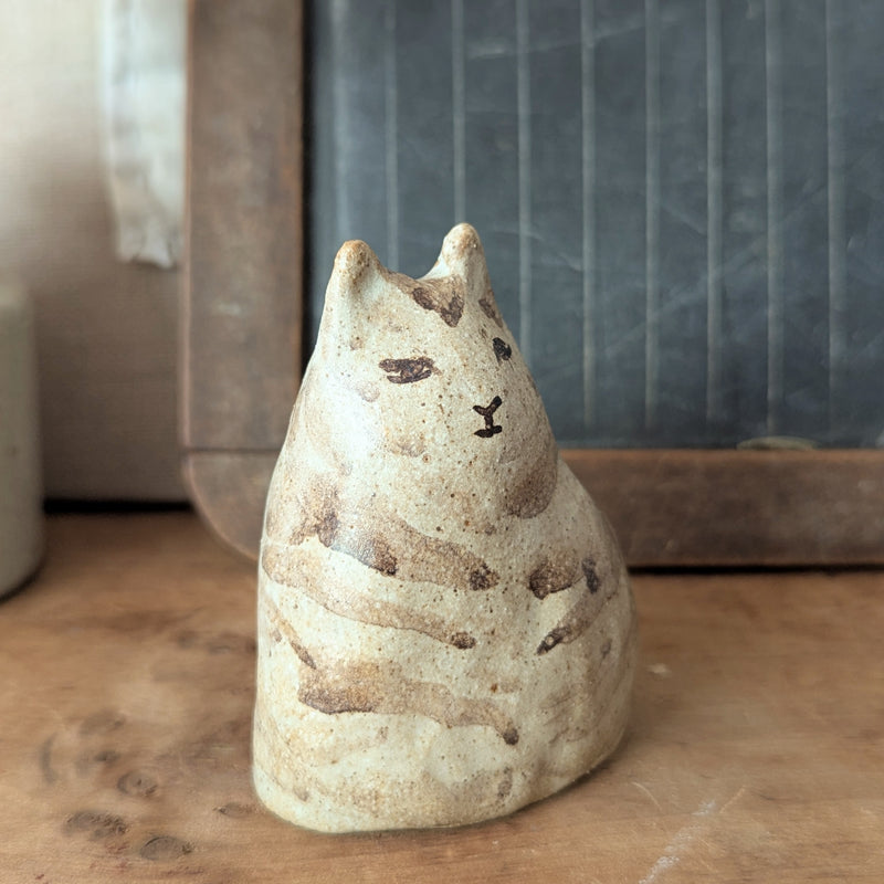 Ceramic cat-shaped object on a wooden surface with a blurred background

Pinched Fat Cat ceramic sculpture by Charlotte Salt sowa Boston small business gift shop boutique store