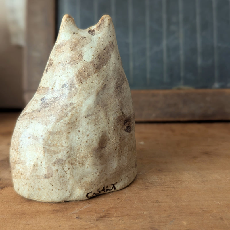 Ceramic cat-shaped object on a wooden surface with a blurred background

Pinched Fat Cat ceramic sculpture by Charlotte Salt sowa Boston small business gift shop boutique store