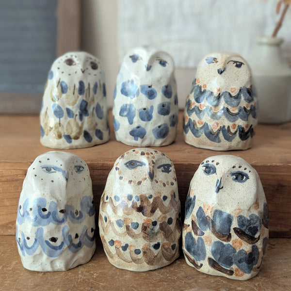 Set of ceramic owl figurines with painted patterns on a wooden surface.

Charlotte Salt handmade and hand-painted ceramic animal sculptures figurines sowa Boston small business gift shop boutique store