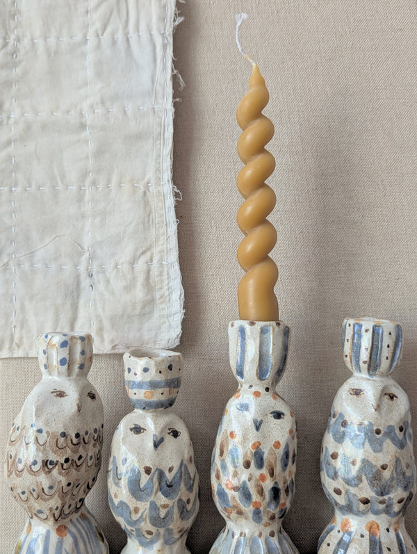 Twisted candle on a stand with decorative owl-shaped candle holders.

Handmade and hand-painted owl candle candlestick holder ceramic clay pinched sculptures by Charlotte salt small business sowa Boston gift shop boutique store