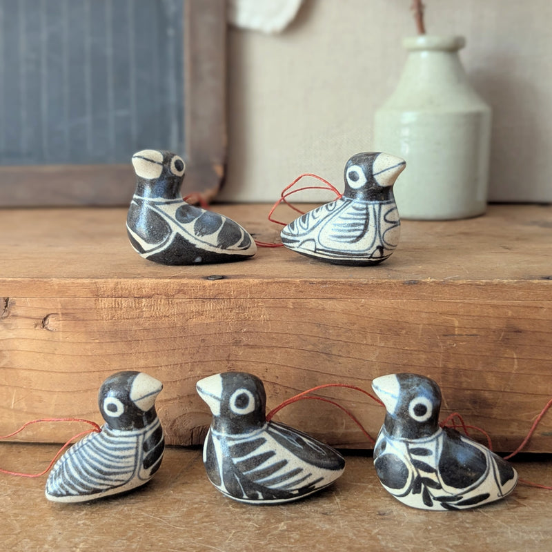 Set of five ceramic bird figurines on a wooden surface with a neutral background

Anna Hepler clar ceramic bird ornaments holiday figurines handmade hand painted New England Boston Massachusetts sowa gift shop store boutique