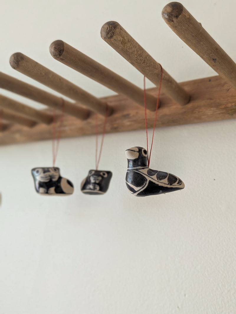 Three ceramic shoes hanging from a wooden rod against a white wall

Anna Hepler clar ceramic bird ornaments holiday figurines handmade hand painted New England Boston Massachusetts sowa gift shop store boutique