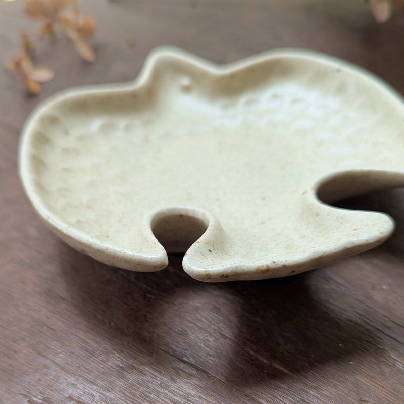 Ceramic bird-shaped dish on a wooden surface