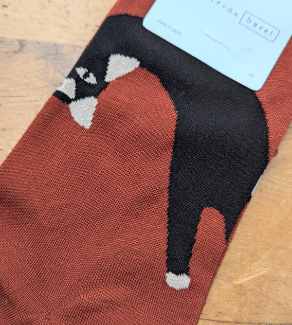 Sock with a cat design on a wooden surface
