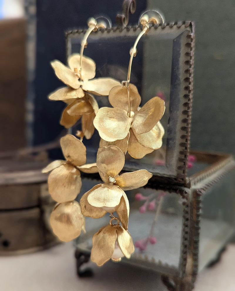 Long chandelier earrings with hanging brass petals and pearl accents 