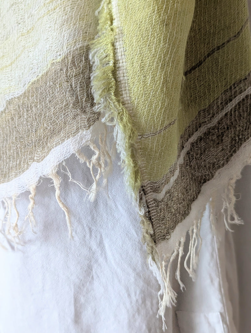 Pale green and beige striped scarf hanging 