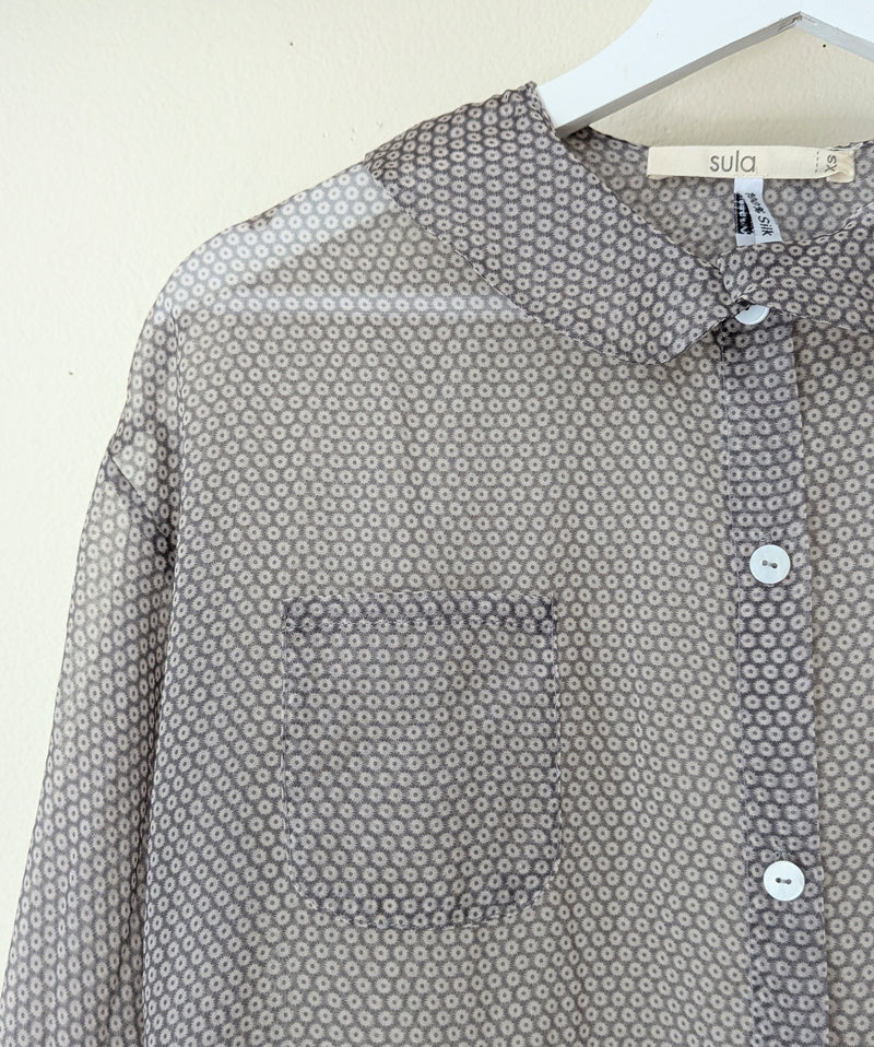 Gray silk organza white patterned shirt on a hanger with 'sula' label.