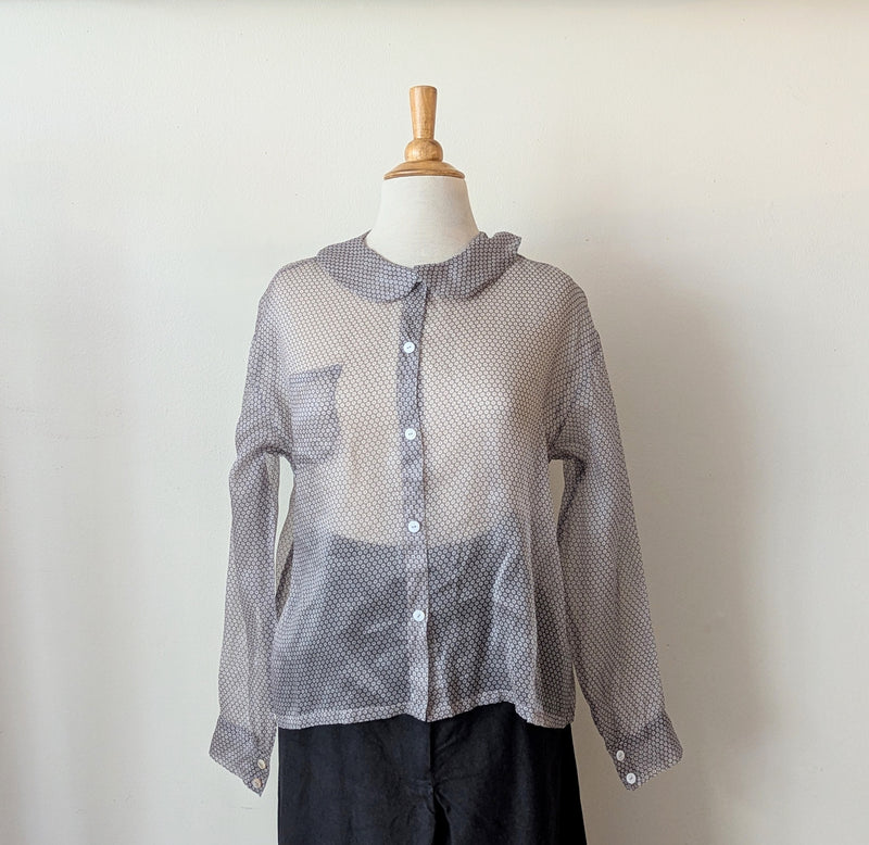 Sheer silk organza gray patterned shirt on a mannequin against a plain background