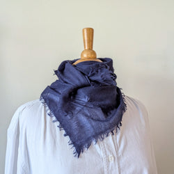 Navy blue cashmere neckerchief scarf on a mannequin with a white background