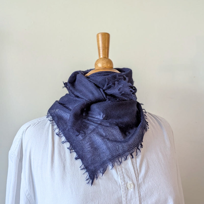 Navy blue cashmere neckerchief scarf on a mannequin with a white background