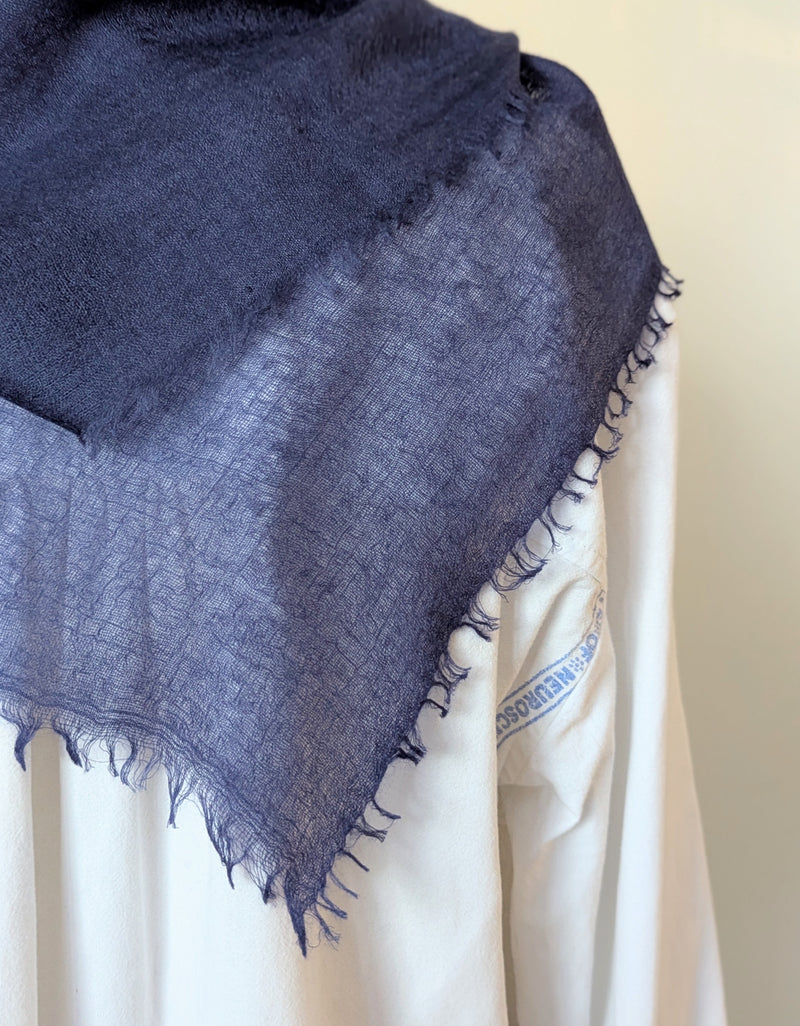 Navy blue cashmere neckerchief scarf on a mannequin with a white background