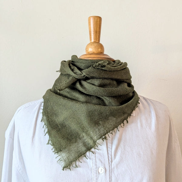 Green cashmere neckerchief scarf on a mannequin with a white background