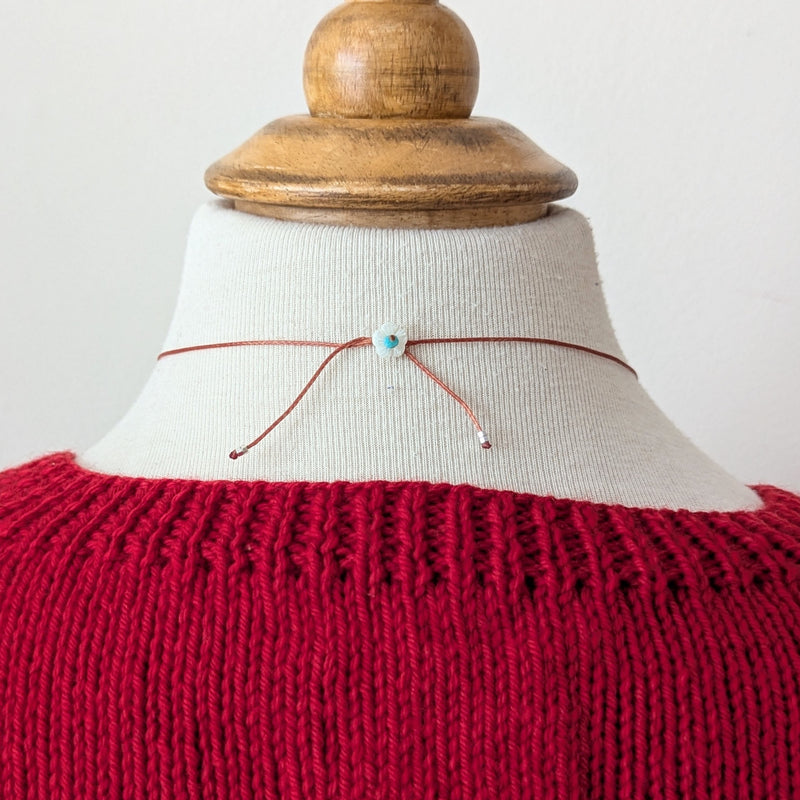 back of necklace with a flower bead