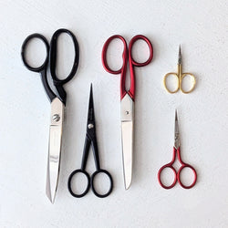 Set of various pairs of Italian scissors from studio Carta on a light gray background