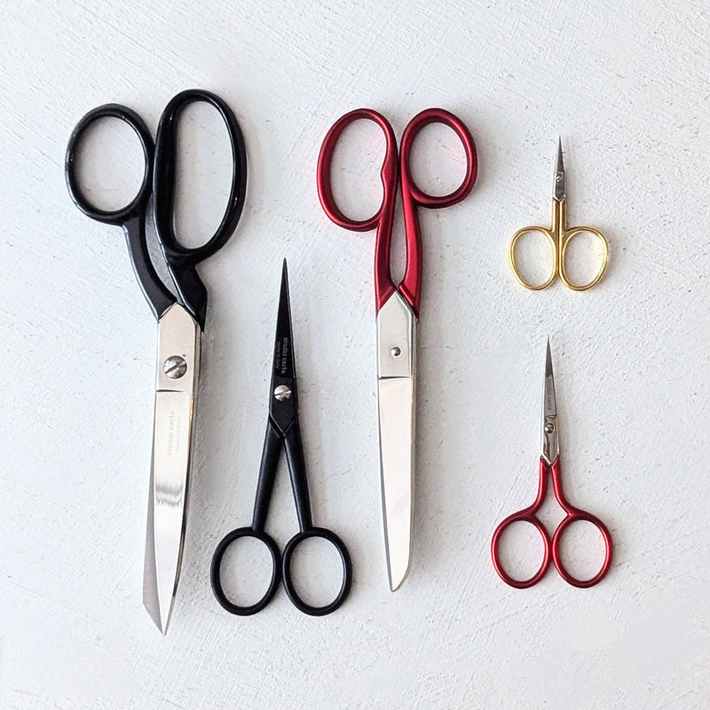 Set of various pairs of Italian scissors from studio Carta on a light gray background