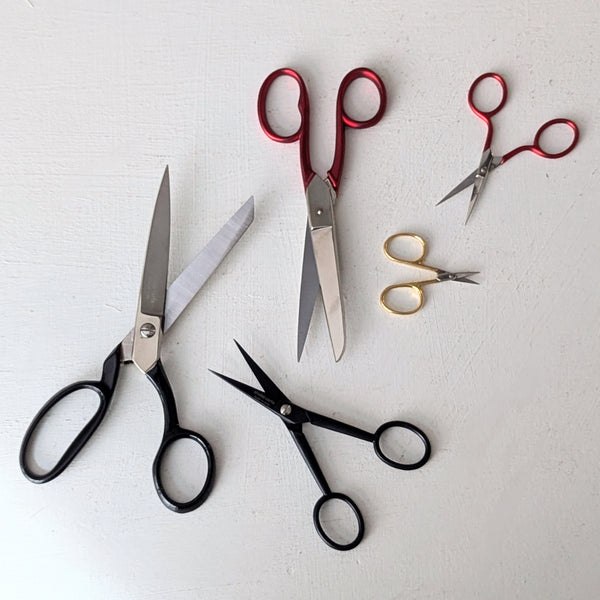 Set of various pairs of Italian scissors from studio Carta on a light gray background