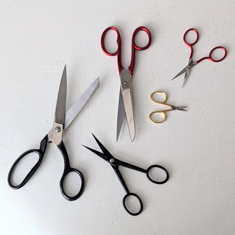 Set of various pairs of Italian scissors from studio Carta on a light gray background
