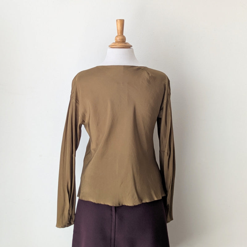 Tobacco brown long-sleeve draped silk top from Susanne Bommer on a mannequin against a white background