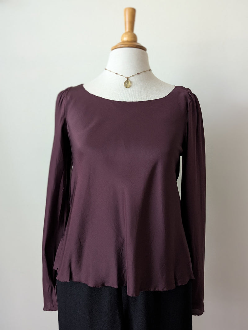 Susanne Bommer silk puff shoulder bordeaux long-sleeve top on a mannequin