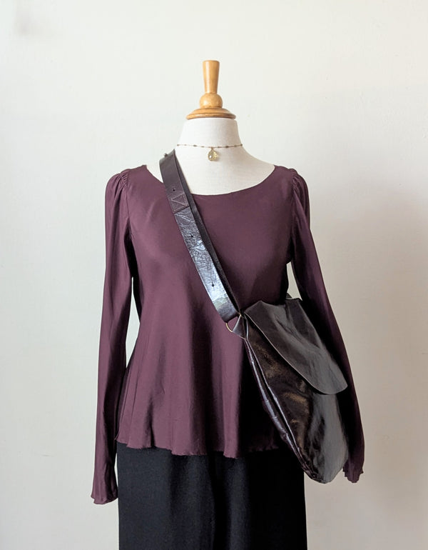 Mannequin wearing a purple top with a Stitch and Tickle Passy Bag in Espresso  on a plain background
