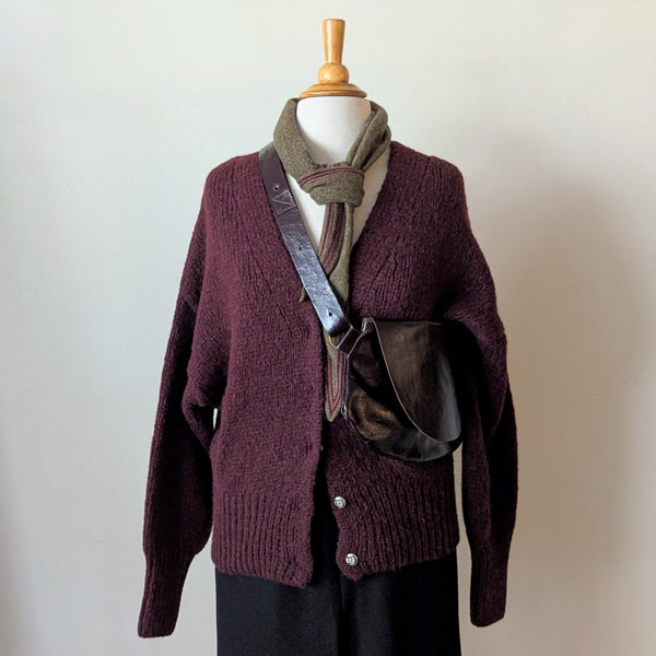 Mannequin wearing a maroon knitted cardigan with a Stitch & Tickle Passito leather bag in Espresso and scarf against a plain background