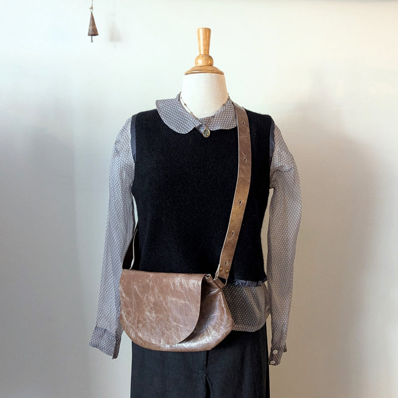 Mannequin wearing a black sweater with a sheer overlay and a Stitch and Tickle Passito bag in Chai  