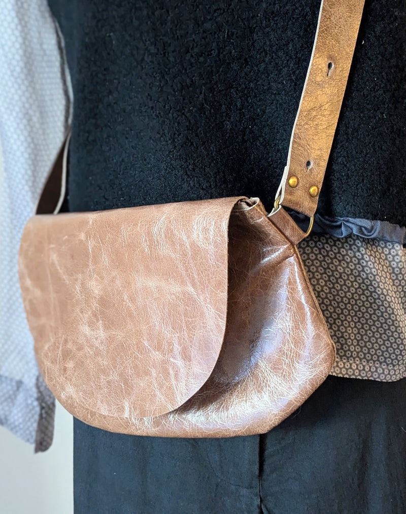 Stitch and Tickle Passito bag in Chai  over a person wearing a black top.