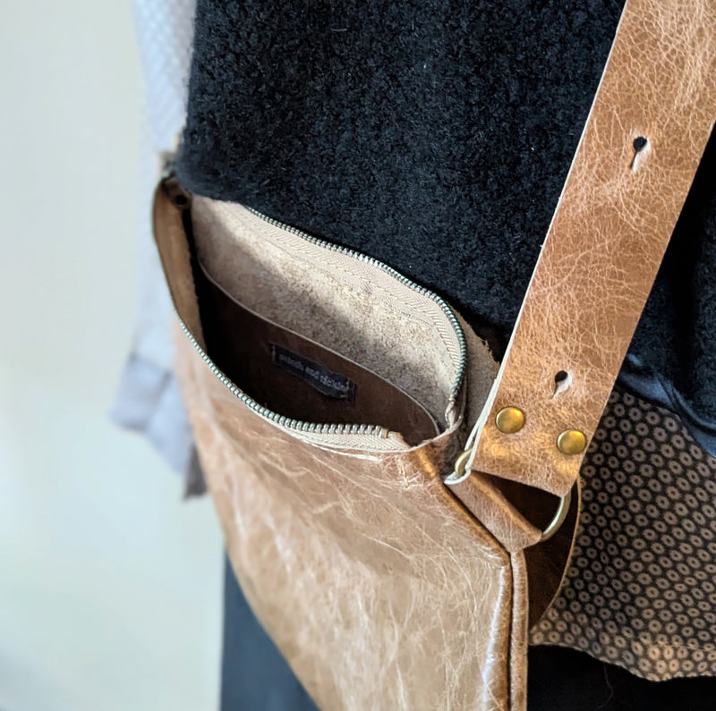 Close-up of a Stitch and Tickle Passito bag in Chai with a strap, on a light background