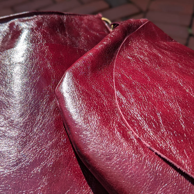 Stitch and Tickle Short Passy Bag in Wine sitting in sunlight