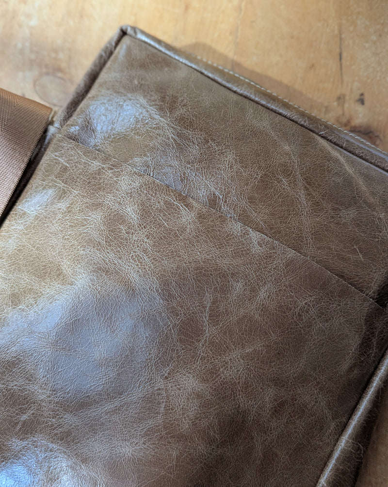 Stitch & Tickle Bourvil Bag in Chai on a wooden surface