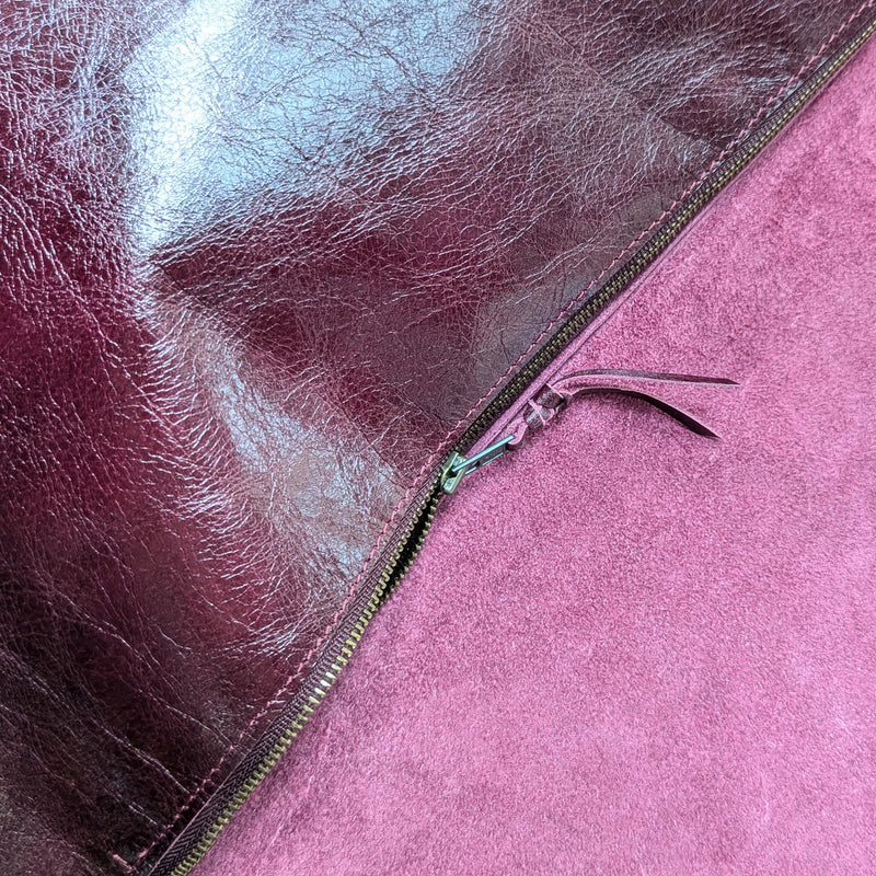 Close-up of a Stitch and Tickle Short Passy Bag in Wine with a zipper, showing texture and color.