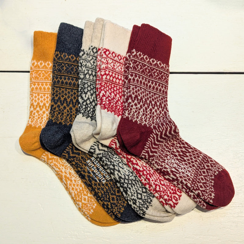 Four pairs of patterned socks in dark red and white, light red and white, black and white, navy and yellow, and yellow and white