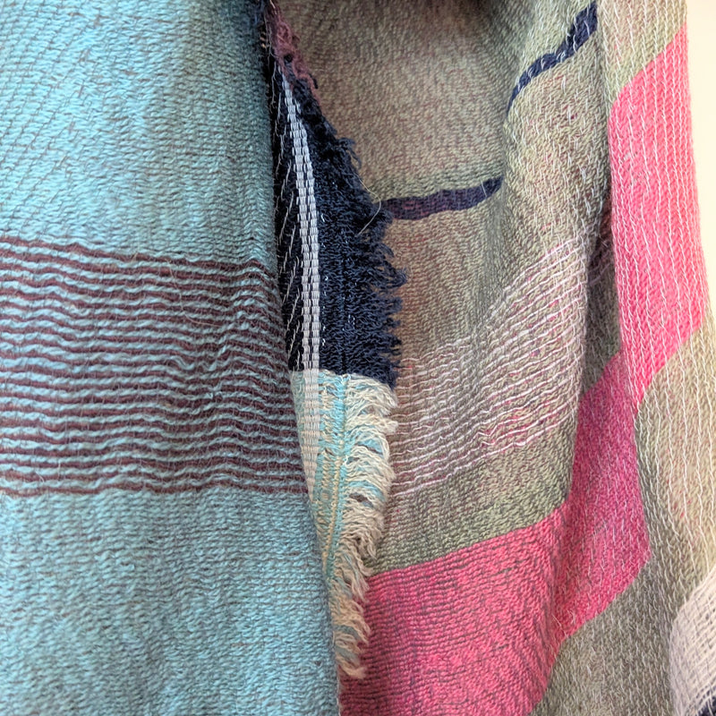 Close-up of a textured fabric with multicolored stripes.