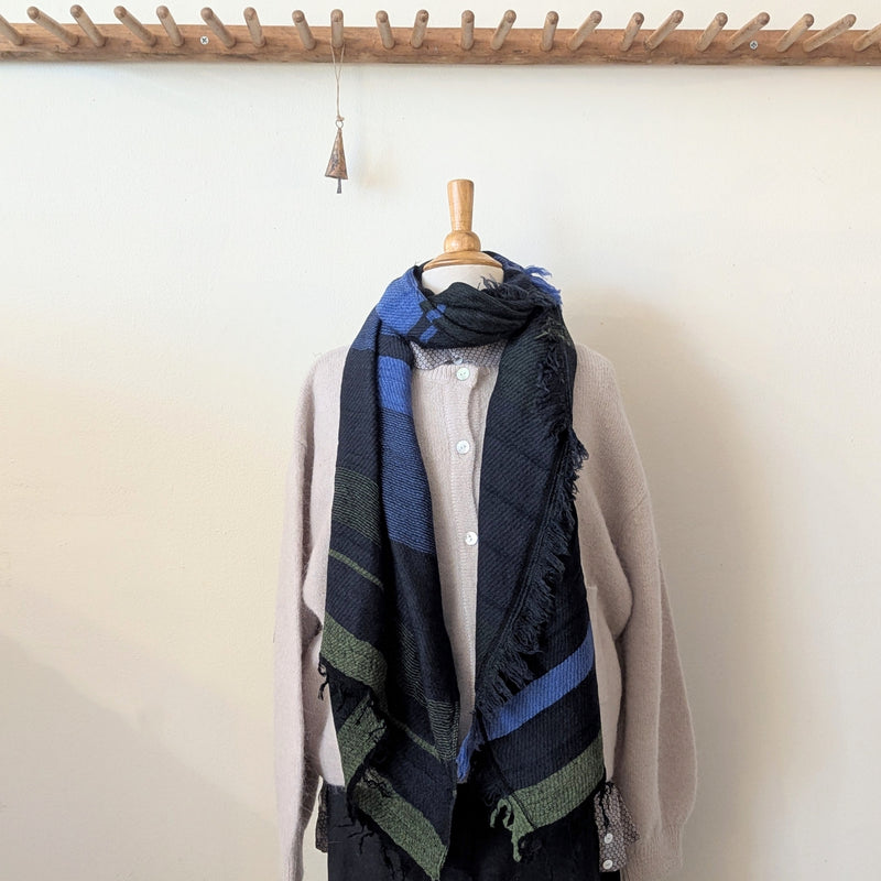 Mannequin wearing a scarf with a plain background