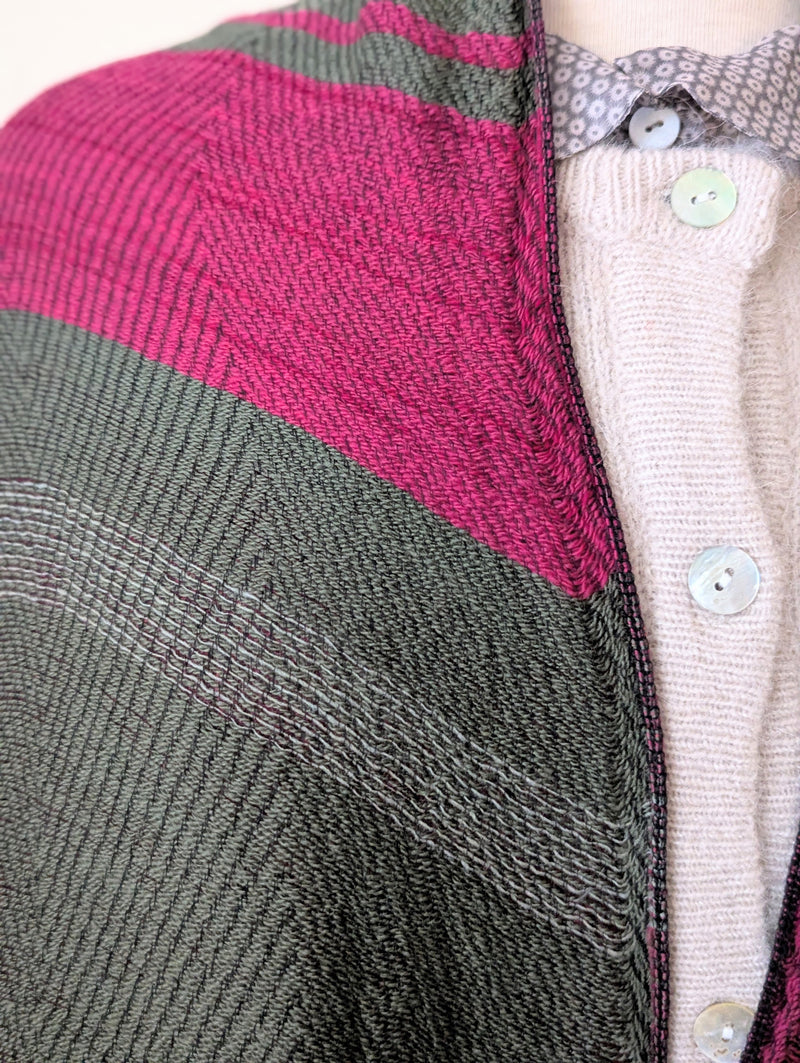 Close-up of a textured fabric with pink and gray pattern