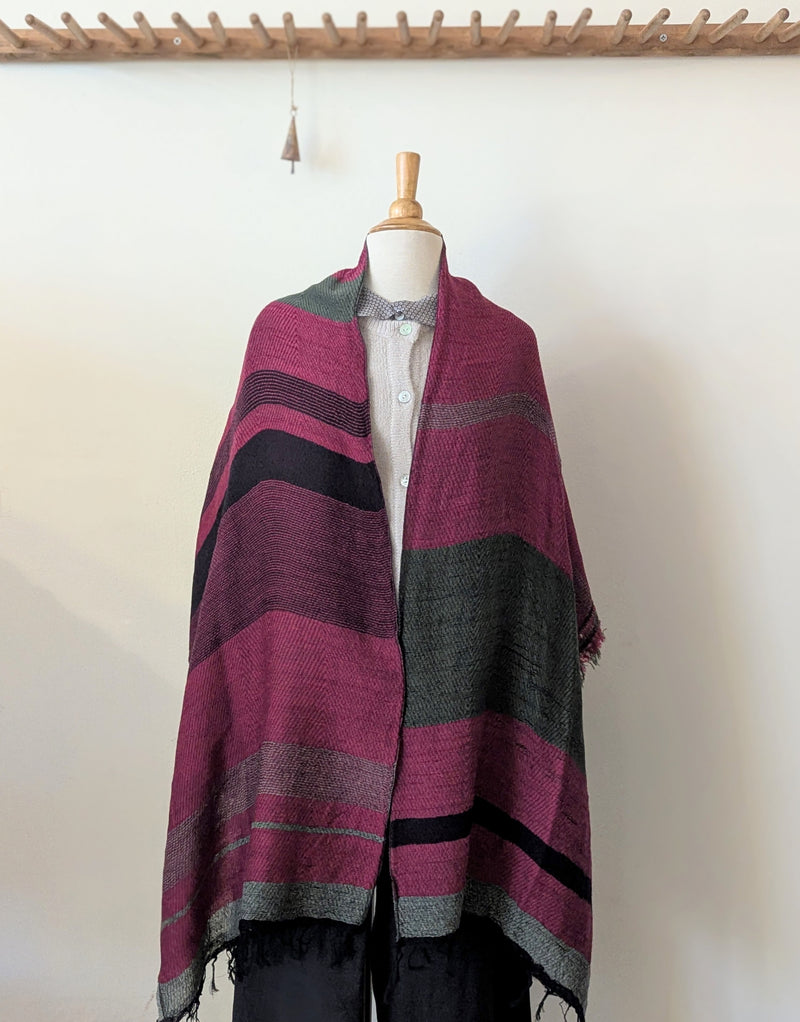 Mannequin wearing a striped scarf with a white background