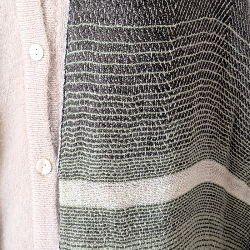 Close-up of a textured fabric with a patterned design on a neutral background
