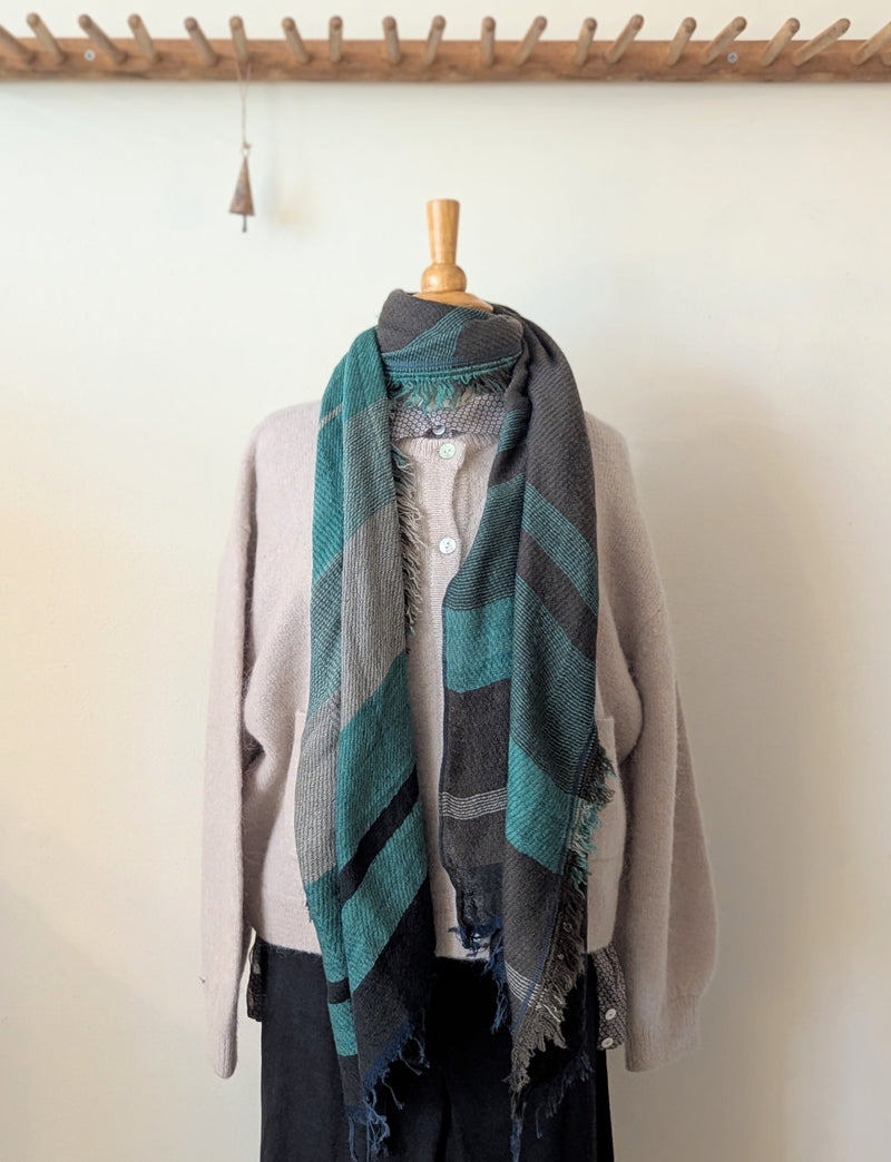 Mannequin wearing a scarf with a neutral background