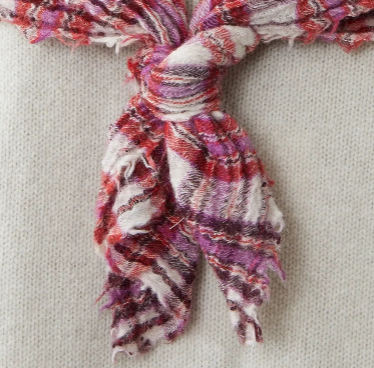 Colorful knotted scarf on a neutral background