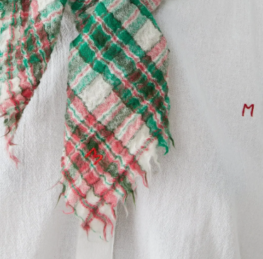 Gingham scarf with red and green patterns on a white background