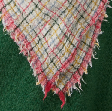 Gingham fabric with pink, yellow, blue, green and white pattern on a green background
