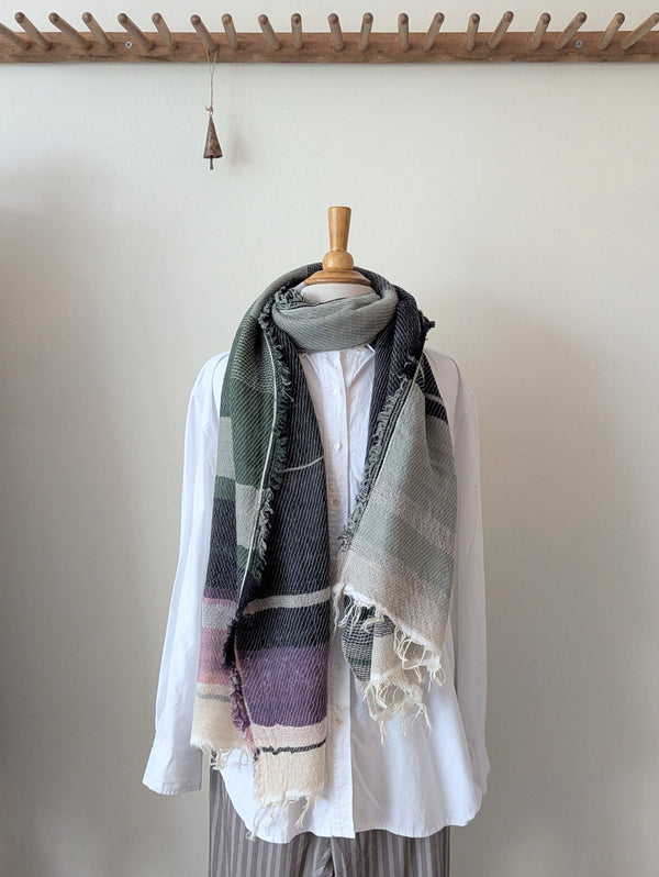 Mannequin wearing a white shirt with a patterned scarf draped over it against a plain background