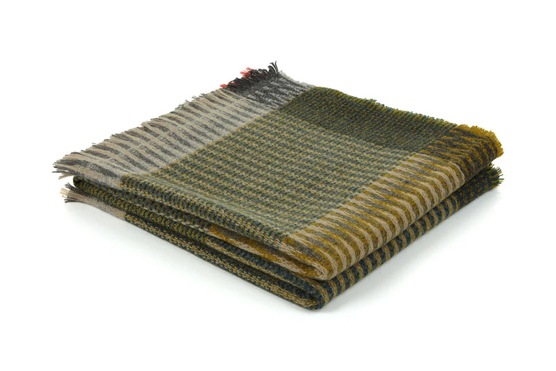 Folded plaid blanket with green and brown colors on a white background