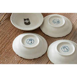 Four ceramic bowls with animal illustrations on a wooden surface
